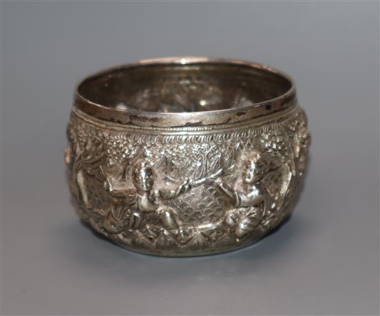 A rare Burmese white metal miniature bowl, embossed with figures in landscape scene, floral mark to base, height 44mm.